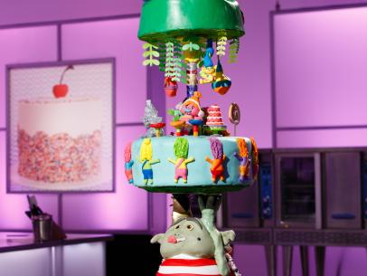 A Trolls-themed cake display created by Joyce Marcellus and Kassy Jimenez during the final challenge, as seen on Food Network's Cake Wars, Season 4.
