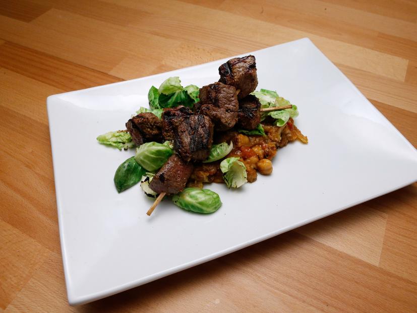 Mentor Anne Burrell's Dry Spice Rubbed Lamb Loin Skewers with "Indian" Capponata is displayed, as seen on Food Network's Worst Cooks in America, Season 9.