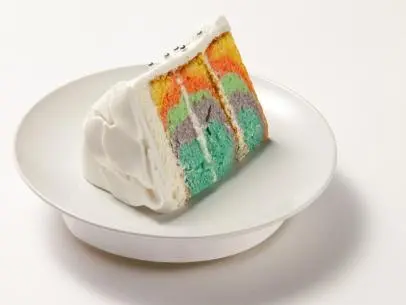 The White Tie Dye cake made by finalist Samantha Brown for the final episode and challenge of Worst Bakers In America.  Samantha made a multi layed cake with different layers of colored cake batter, covered by a white fondant, and topped with white leaves and small silver sugar balls, as seen on Food Network's Worst Bakers In America, Season 1.
