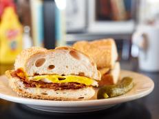 When Jeff Mauro was in the mood to make comfort food on Sandwich King, the first place he went for inspiration was the Palace Grill in Chicago. The Ultimate Grilled Cheese is stuffed with three types of cheese and four strips of bacon, and the meatloaf sandwich is served with gravy on the side.