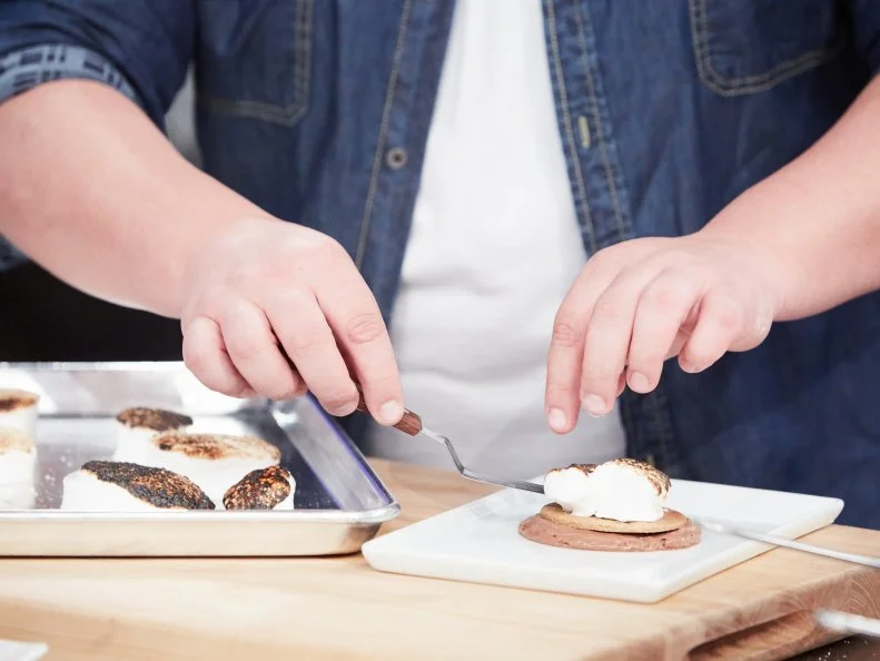 Host Duff Goldman preparing his dish, Homemade S'Mores, as seen on Food Network's Holiday Baking Championship: Duff's Sweet Spot, Season 3.
