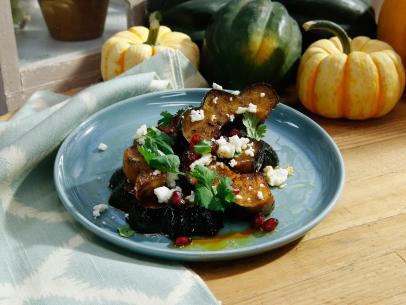 Marcela Valladolid's Herb Roasted Acorn Squash with Queso Fresco and Pomegranate is displayed, as seen on Food Network's The Kitchen, Season 11.