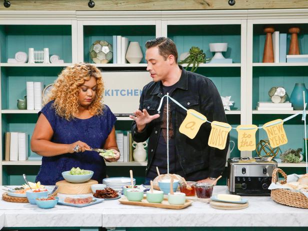Host Jeff Mauro demonstrates his Toast Bar for fellow host Sunny Anderson during a segment on Lazy Brunch, as seen on Food Network's The Kitchen, Season 11.