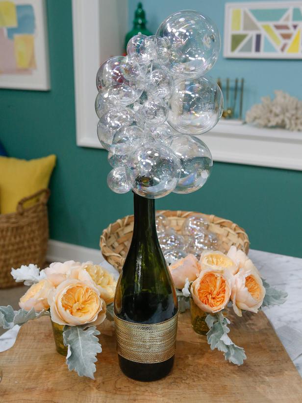 Marcela Valladolid's champagne bottle centerpiece is displayed, as seen on Food Network's The Kitchen, Season 11.