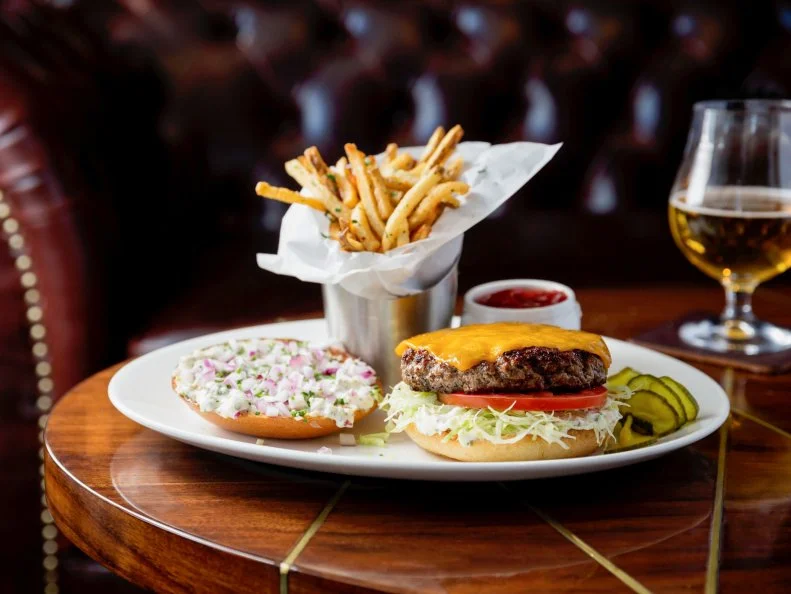 Long home to a cavernous chain restaurant, the space that now houses Baltaire has been remarkably transformed to become this chic steakhouse. Executive Chef Travis Strickland is the man behind the Butchered Burger, a patty made with prime brisket, chuck and short rib (ground and blended in-house) and complemented by butter pickles, sauce gribiche, diced red onion, sliced tomato, shredded lettuce and cheddar cheese.