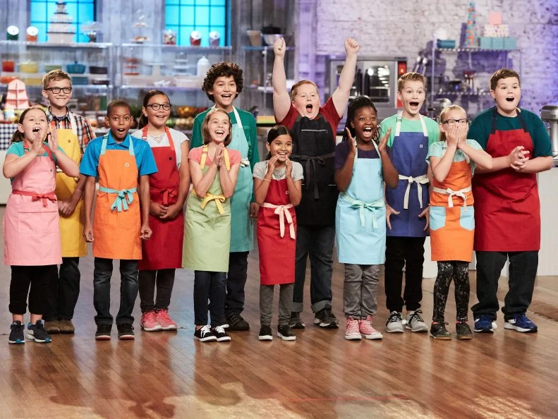 Contestants Brooke Cumberland, Dylin Musgrove, Reese Smith, Keili Gorczyca, Audra Tow, Justice Faustina, Maya Jindal, Jason Intravartolo, Kaniyah Cary, Cole Frederickson, Charlotte D’Arabian and Aidan Berry during the reveal of the Main Heat, as seen on Food Network's Kids Baking Championship, Season 3.