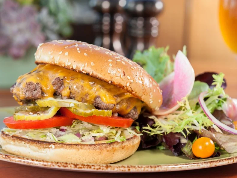 With a position over the rolling greens of one of the country's best golf courses, the view at The Grill could be the main draw. The Drugstore Hamburger, however, ensures that the food stands up to the atmosphere. Named for its old-fashioned inspiration, the griddle-cooked burger is one of the best in town. Sheathed in glossy Cheddar, the ground chuck — from Niman Ranch — is topped with chipped sweet onion, shreeded lettuce, pickles and tomato, with a swab of homemade mayonnaise and choice of fries or a salad  on the side.