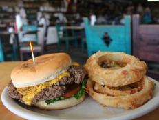 The Hubcap burger with onion rings and fried pickles at Cotham's Mercantile in Scott, Arkansas as included in Arkansas's Most Iconic Eats for FoodNetwork.com