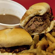 A French dip sandwich with jus and Texas Toothpicks at Ed Walker's Drive In in Fort Smith, Arkansas as included in Arkansas's Most Iconic Eats for FoodNetwork.com