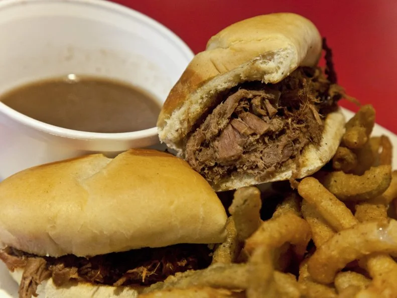 A French dip sandwich with jus and Texas Toothpicks at Ed Walker's Drive In in Fort Smith, Arkansas as included in Arkansas's Most Iconic Eats for FoodNetwork.com