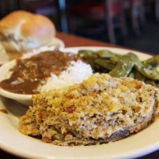 A veggie plate with eggplant casserole, brown gravy on rice and green beans with a roll at Franke's Cafeteria in Little Rock, Arkansas as included in Arkansas's Most Iconic Eats for FoodNetwork.com