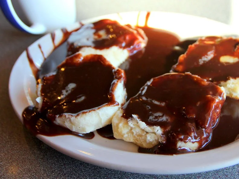 Chocolate gravy over biscuits at Gadwall's Grill in North Little Rock, Arkansas as included in Arkansas's Most Iconic Eats for FoodNetwork.com