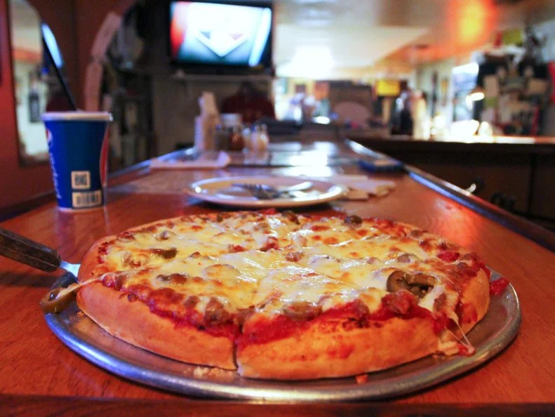 A beef and green olive pizza at Tommy's Famous A Pizzeria in Mountain View, Arkansas as included in Arkansas's Most Iconic Eats for FoodNetwork.com