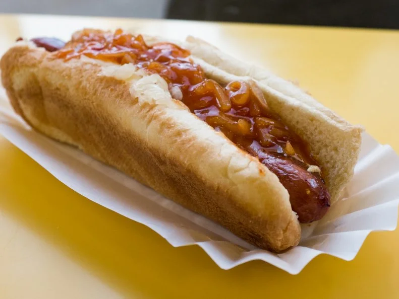 When German immigrants began selling sausages on street corners in the mid 19th century, New York City and hot dogs became — pardon the pun — inextricably linked. To this day, hot dog carts dot corners throughout Manhattan. The city has recently gone through a gourmet frank renaissance, with a slew of fast-casual joints and even high-end restaurants shelling weenies with creative toppings. Even so, the old-school storefront of Gray’s Papaya reigns supreme. The canary-yellow shop serves crisp, griddled Sabrett dogs on classic white bread buns, nestled in a traditional white paper wrapper. Get one loaded with sauerkraut and onions for just $2.50.