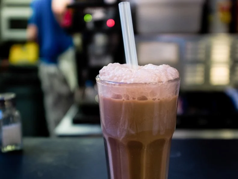 The New York Egg Cream contains neither eggs nor cream. Instead, it’s a strange-sounding, highly delicious combination of milk, seltzer and chocolate syrup (preferably Fox’s U-Bet), stirred together in a Coke-style glass just before serving, so it develops a nice, frothy head. Most historians say the egg cream was created in the early 1900s by Louis Auster, a Jewish candy shop owner, who sold 3,000 of them a day in his Brooklyn storefront, Ratner’s Dairy Restaurant. These days, the egg cream can be found at delis and diners throughout the boroughs. Shopsin’s, a tiny diner inside the Lower East Side’s Essex Street Market, serves one of the top renditions in town: rich and invigorating with a thick head and plenty of cascading, miniature bubbles. 