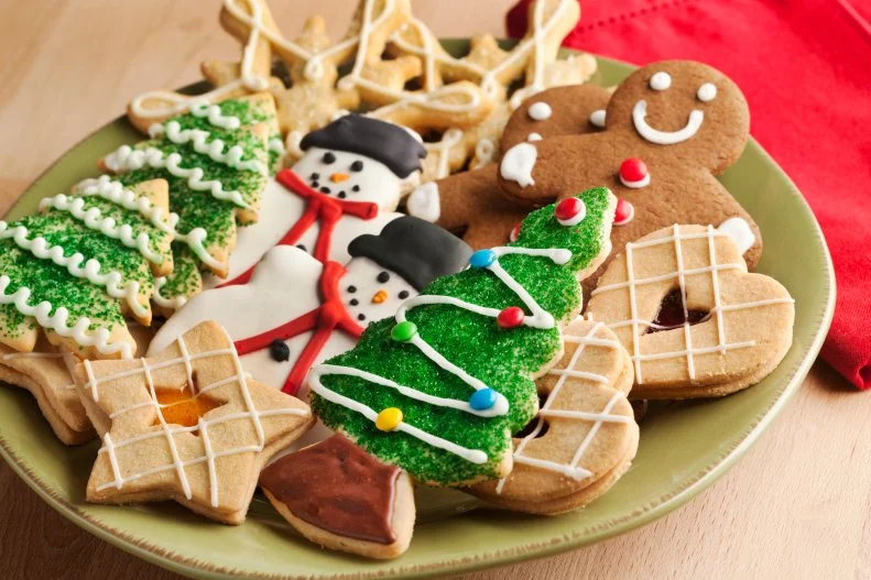 Subject: A plate filled with Christmas sweet cookies decorated with frosting and icing.