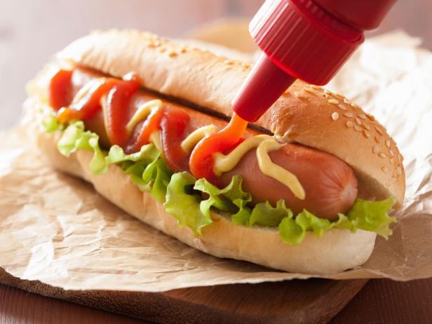 hot dog with ketchup mustard and lettuce