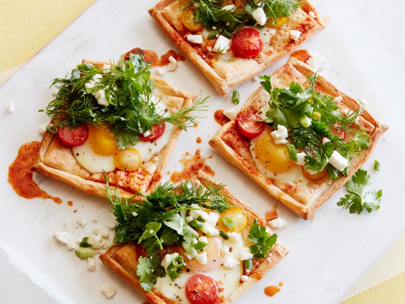 FNK KIDS CAN MAKE: BAKED EGGANDHARISSA TARTS Food Network Kitchen Food Network Puff Pastry, Eggs, Red and/or Yellow Cherry Tomatoes, Harissa, Olive Oil, Parsley and/or Dill Leaves, Feta Cheese, Scallion, Lemon Juice