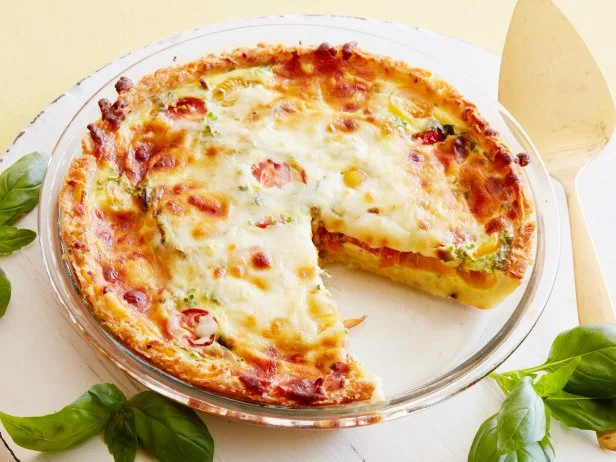 FNK KIDS CAN MAKE: HASH BROWN TOMATO AND MOZZARELLA QUICHE Food Network Kitchen Food Network Olive Oil, Hash Browns, Eggs, HalfandHalf, Red and Yellow Cherry Tomatoes, Basil, Chives, Mozzarella