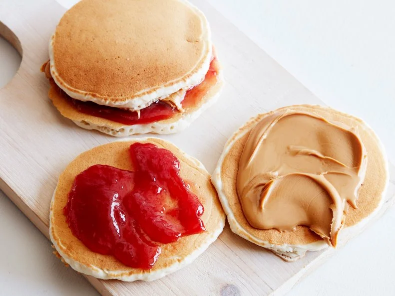 12 THINGS YOU SHOULD MAKE WITH PANCAKES  1. Pancake Grilled Cheese 2. BLT Pancake 3. Peanut Butter and Jelly Pancake Sandwich 4. Pancake Ice Cream Sandwich 5. Pancake Tacos 6. Pancake Whoopie Pies 7. PancakeCake 8. Pancake Bread Pudding 9. Pancake Parfait 10.Pancake Eggs Benedict 11.Pancake Quesadilla 12.Pancake Canapes 12 Things You Should Make with Pancakes Food Network Kitchen Food Network Grilled Cheese, BLT, Peanut Butter and Jelly, Tacos, Ice Cream Sandwich, Whoopie Pies, PancakeCake, Bread Pudding, Pancake Parfait, Eggs Benedict, Quesadilla, Canapes