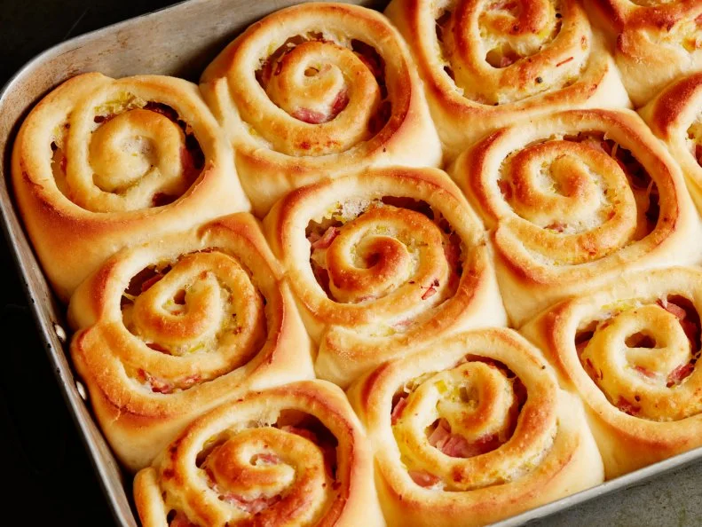 FNK HAMANDCHEESE BUNS Food Network Kitchen Food Network Whole Milk, Active Dry Yeast, Sugar, Unsalted Butter, Eggs, Allpurpose Flour, Leek, Dry White Wine, Gruyere Cheese, Sliced Deli Ham