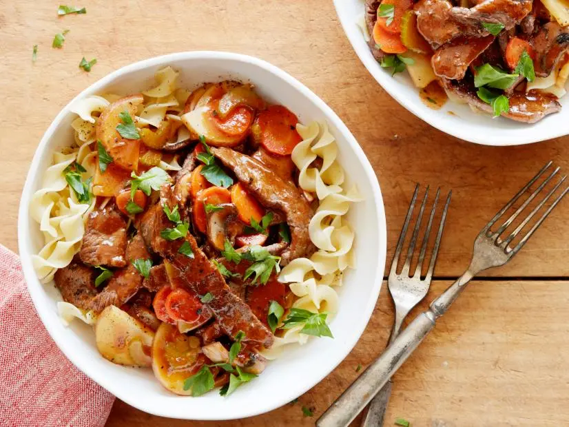 FNK POT ROAST STIRFRY Food Network Kitchen Food Network Beef Sirloin, Cornstarch, Small Red Bliss Potatoes, LowSodium Beef Broth, Soy Sauce, Vegetable Oil, Cremini Mushrooms, Carrots, Celery, Garlic, Tomato Paste, Unsalted Butter, Parsley, Wide Egg Noodles
