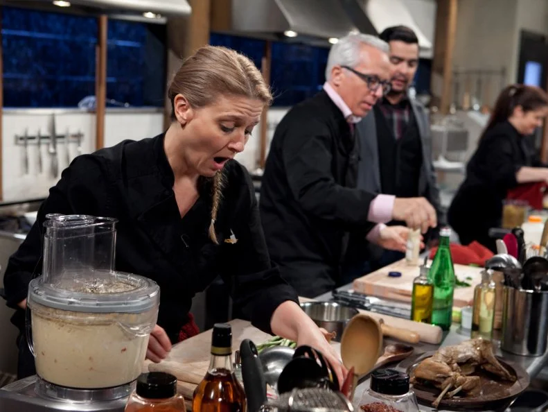 Chopped: After Hours host Aaron Sanchez talks to chef Geoffrey Zakarian while he and chefs Amanda Freitag and Alex Guarnaschelli work on their entrees that must include: deep dish pizza dough, rabbit escabeche, swiss chard and pineapple cheese spread, as seen on Food Network's Chopped: After Hours.