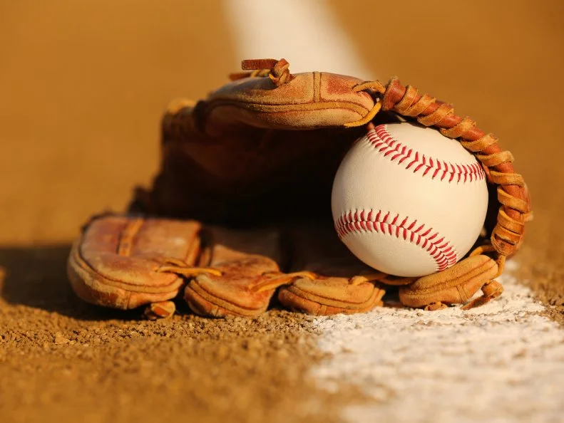 New Baseball in a Glove in the Infield