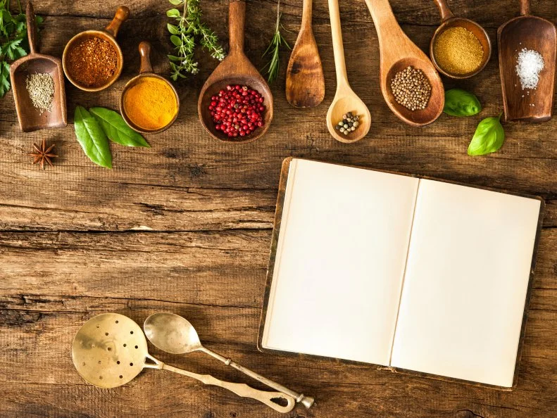 Blank cookbook and spices on wooden table