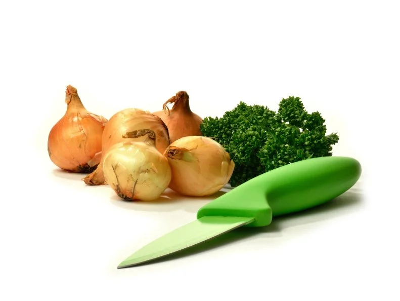 High quality product image from my Kitchen Essentials Series
of fresh green parsley sprigs with white onions and modern green paring knife against a white background. Copy space.