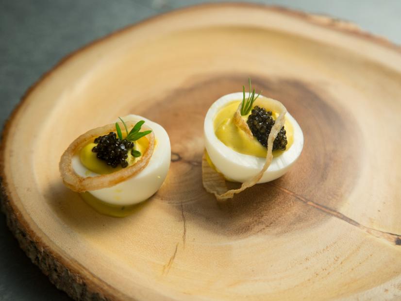 Food beauty of Béarnaise deviled eggs, Osetra caviar, crispy shallots and tarragon, from the team with Host Tyler Florence and contestant Lawrence Crawford, during the final menu challenge, as seen on Food Network’s Worst Cooks In America, Season 8.