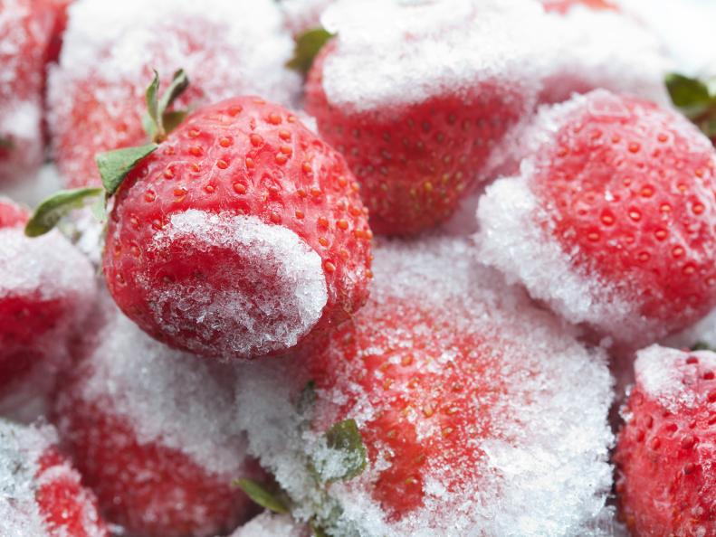 Frozen strawberries closeup. Detailed cold fruit image. soft focus