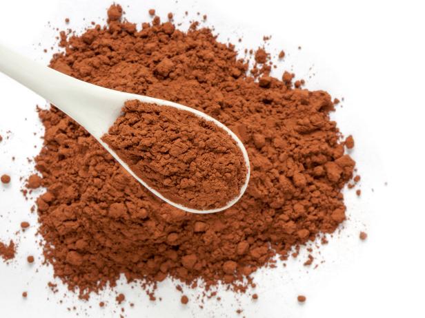 Selective focus of cacao powder on white background