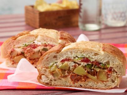 Food Network Kitchen’s Mexican Chorizo and Potato Torta Under a Brick for Summer Slow Cooker/Zucchini Fries/Picnic Brick-Pressed Sandwiches, as seen on Food Network.