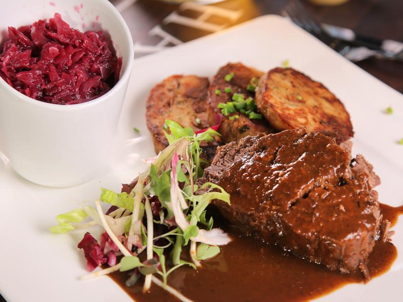 A dish of sauerbraten with pretzel napkin dumplings and red cabbage at Hofbrau's Beer Hall in South Beach, FL as seen on Food Network's Diners, Drive-Ins, and Dives, episode DV2409.