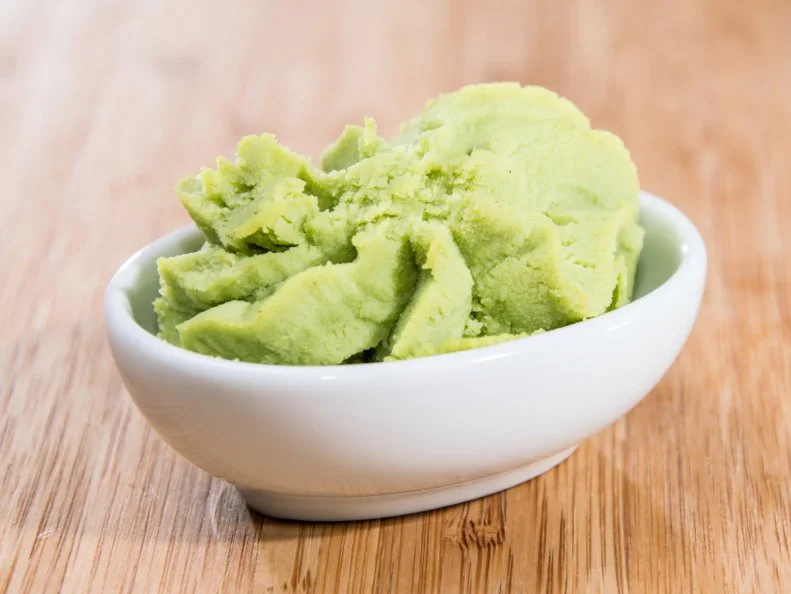 Bowl with Wasabi on wooden background