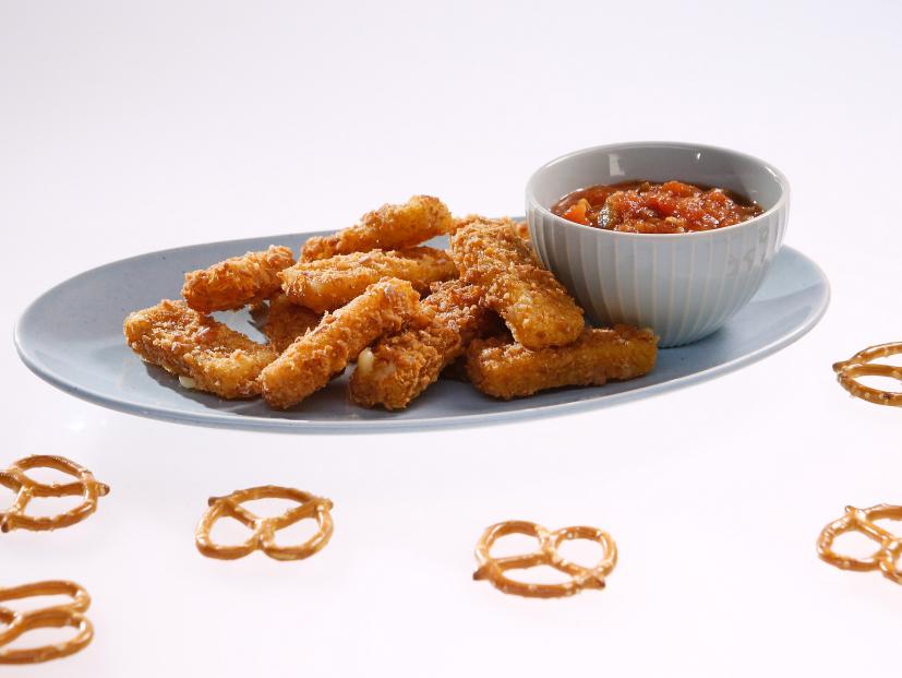 Pretzel crusted cheese sticks are displayed during an episode about the best snacks ever, as seen on Food Network's The Kitchen Sink, Season 1.