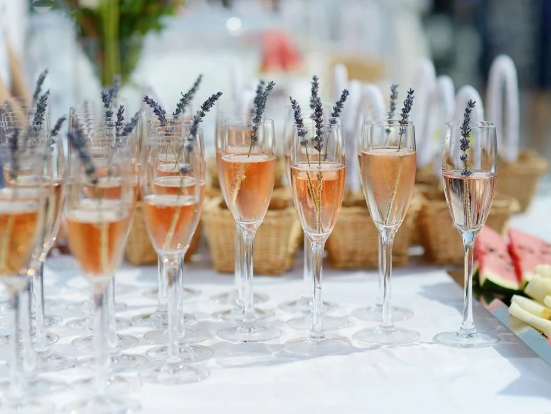 Glasses of with pink champagne decorated with lavender