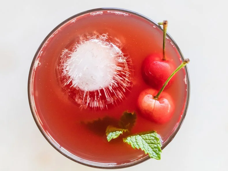 Shrub cocktail made with iced tea, cherries and mint and apple cider vinegar