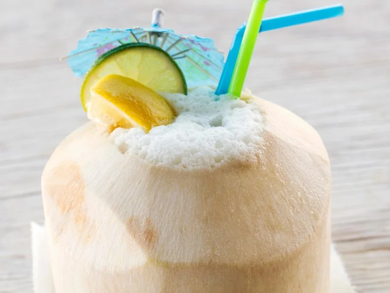 Add equal parts green tea and pineapple juice to the coconut water inside a young pineapple. Food photography and recipe by Jackie Alpers for FoodNetwork.com
