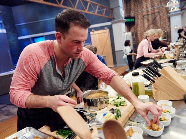 Finalist Aaron Crumbaugh preparing his dish, Asian Style Fried Chicken with Southern Veg and Bacon Pho, for the Mash Up Star Challenge theme, Fried Chicken and Pho, as seen on Food Network Star, Season 12.