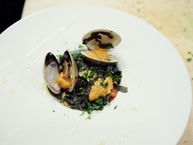 Finalist Damiano Carrara's dish, Clams and Sea Urchin Squid Ink Tagliolini, for the Star Challenge, Guilty Pleasures Dinner, as seen on Food Network Star, Season 12.