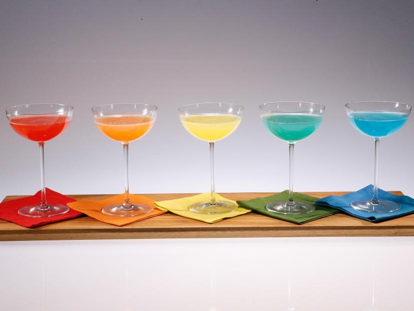 Rainbow mimosas are displayed during an episode about rainbow foods to brighten your day, as seen on Food Network's The Kitchen Sink, Season 1.