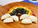 Rainbow pizza is displayed during an episode about rainbow foods to brighten your day, as seen on Food Network's The Kitchen Sink, Season 1.