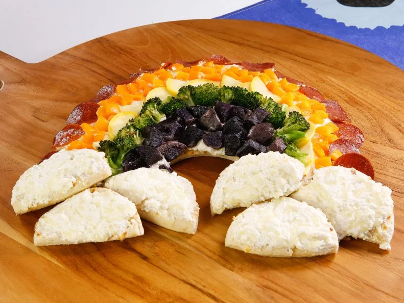 Rainbow pizza is displayed during an episode about rainbow foods to brighten your day, as seen on Food Network's The Kitchen Sink, Season 1.