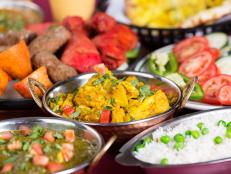 Indian food: assortments of dishes including aloo gobi, chicken tikka masala, rice, garlic naan bread, dal makhni, and vegetables. You might also be interested in these: