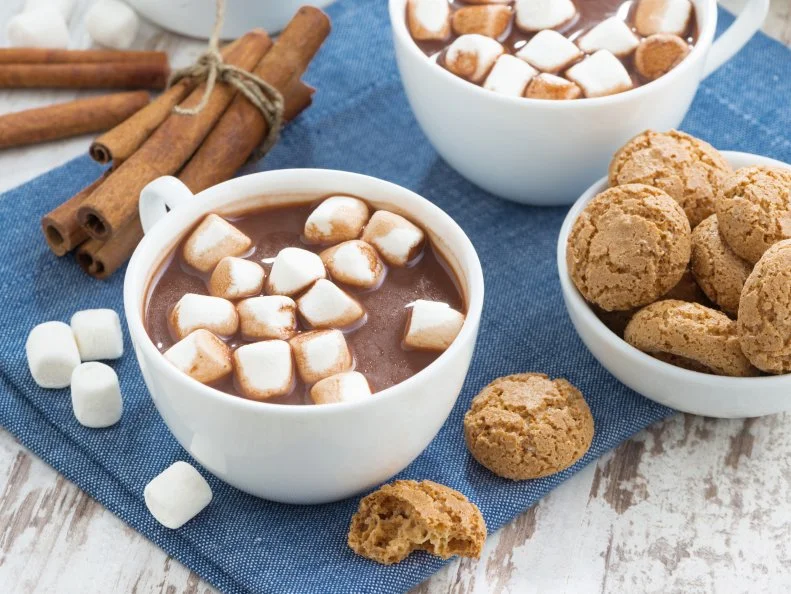 cup of cocoa with marshmallows and almond cookies, top view