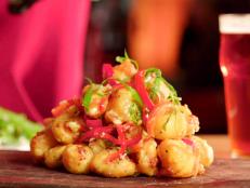 Customers line up out the door for this craft brewery&rsquo;s inventive pub menu. One genius creation is the mozzarella cheese curds, which are fried in a tempura batter made with one of 3 Floyds&rsquo; most-popular brews, the Zombie Dust pale ale. The fried curds come smothered in a tangy homemade kimchi aioli, creating a one-two punch of flavor that makes for one irresistibly funky fermented snack.
