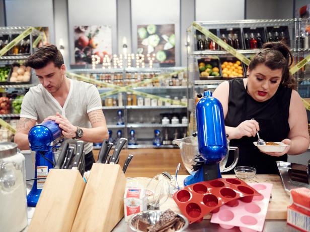 Finalists Erin Campbell and Damiano Carrara preparing their dishes for the Mentor Challenge, Freeze-Out, as seen on Food Network Star, Season 12.