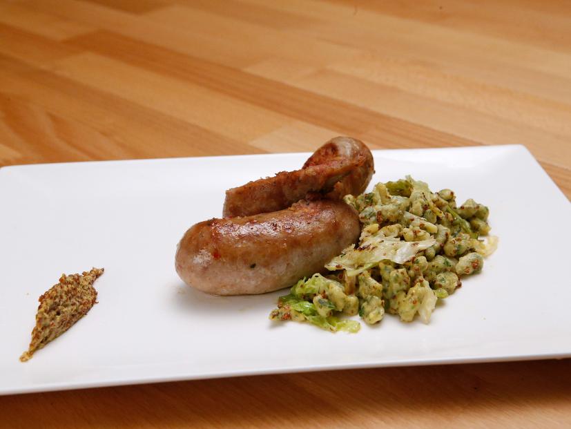 Mentor Anne Burrell's Hand-made Sausage with Herb Spaetzle is displayed, as seen on Food Network's Worst Cooks in America, Season 9.